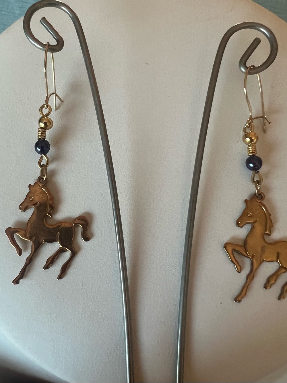 Gold tone galloping horse dangle earrings